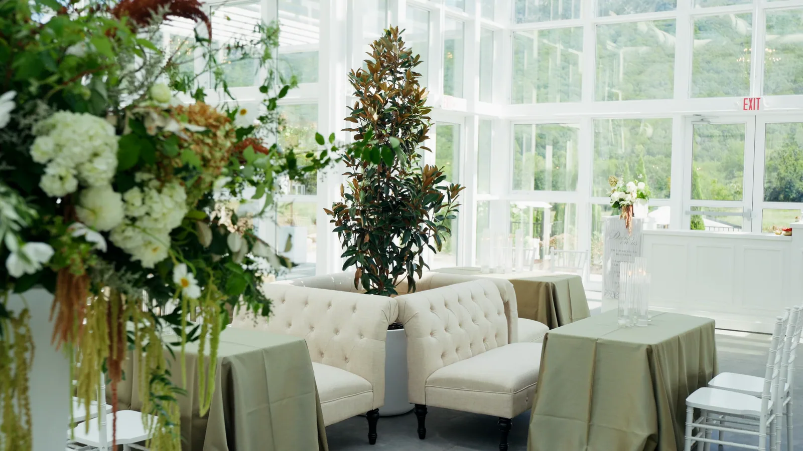 Tables styled in sage and ivory, with hydrangea and amaranthus arrangements